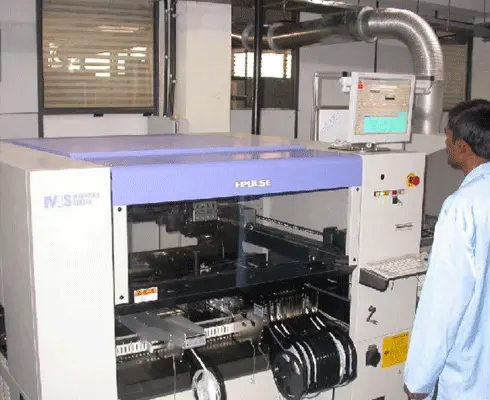 Automated PCB assembly machine operating on an electronics production line in a manufacturing facility