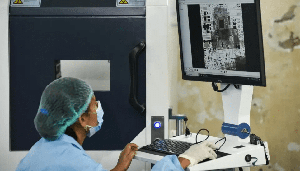 Technician performing X-ray inspection of PCB to ensure quality and precision in electronics manufacturing